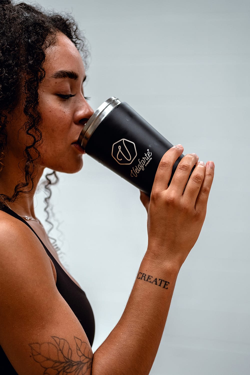 Young woman drinking a Veloforte Protein Shake