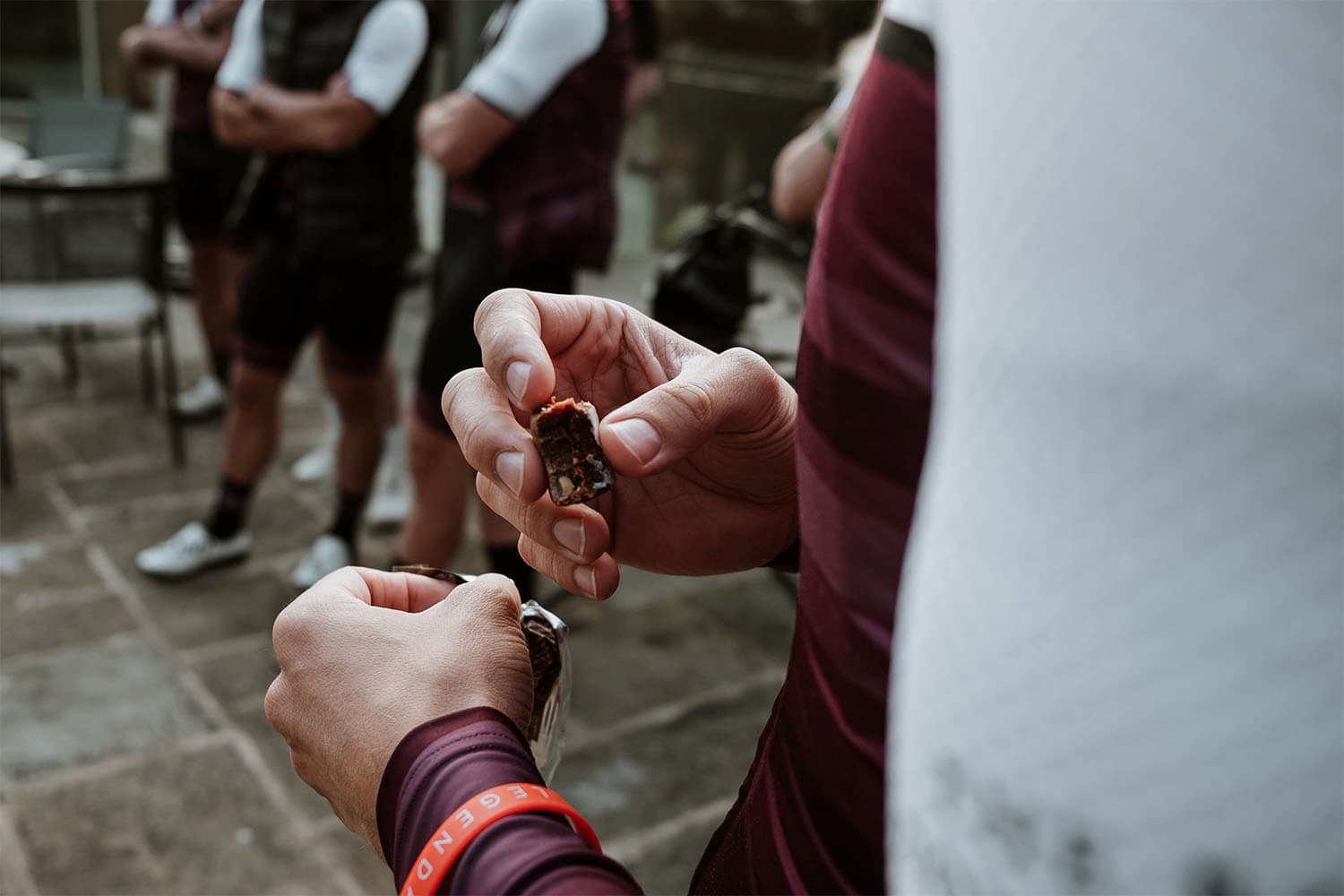 A cyclist is tasting Veloforte energy bars from a table.