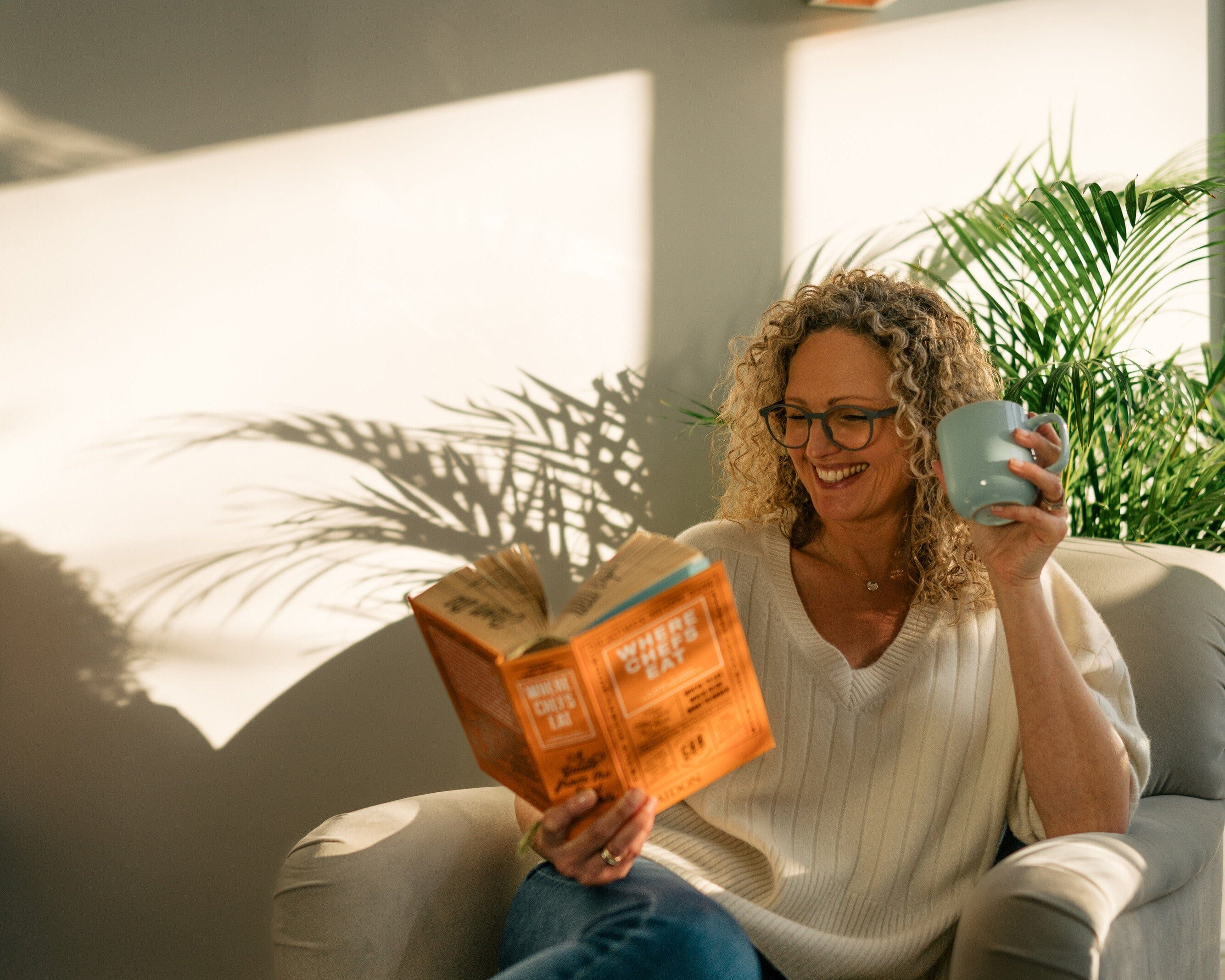 A woman reading & drinking collagen 