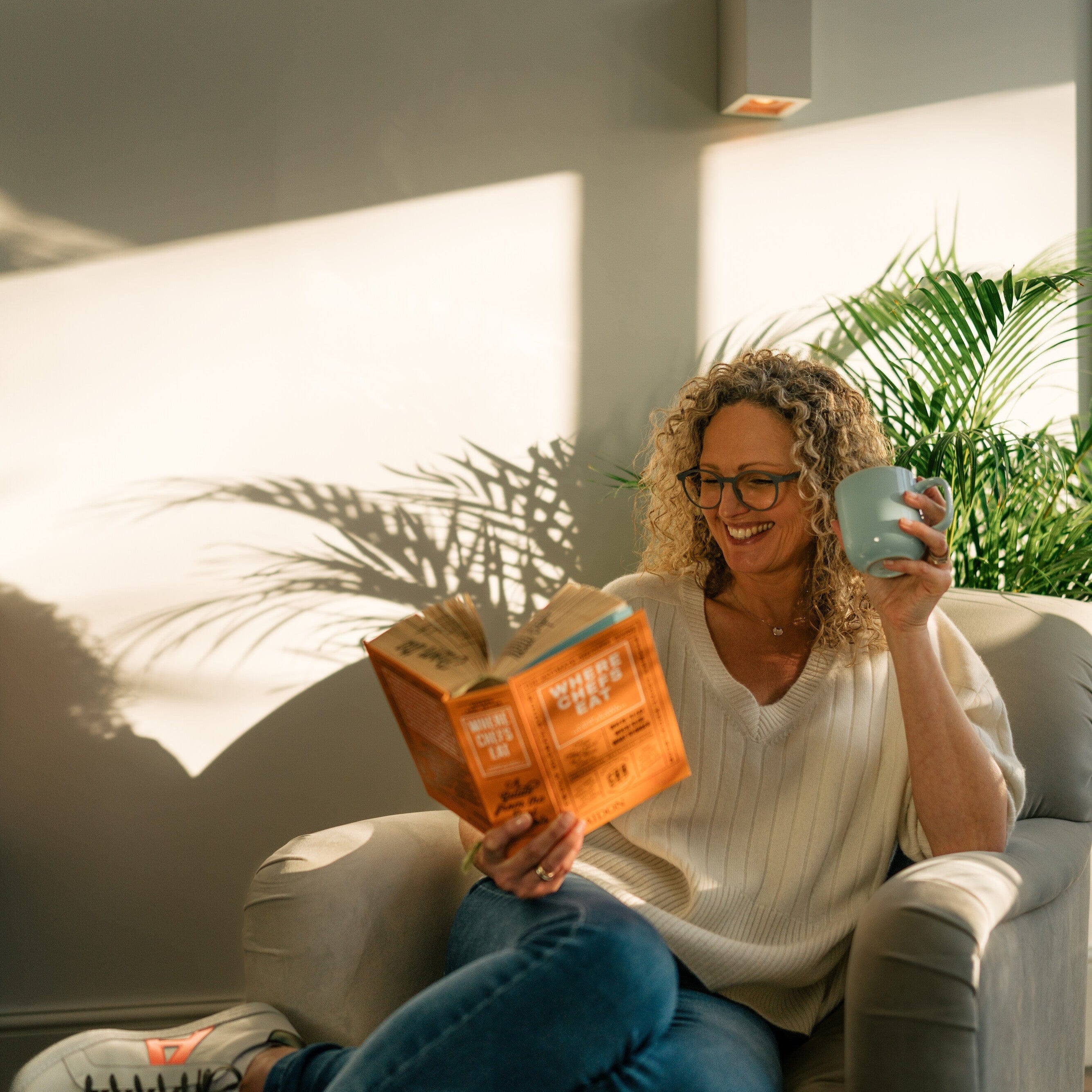 A woman reading & drinking collagen 