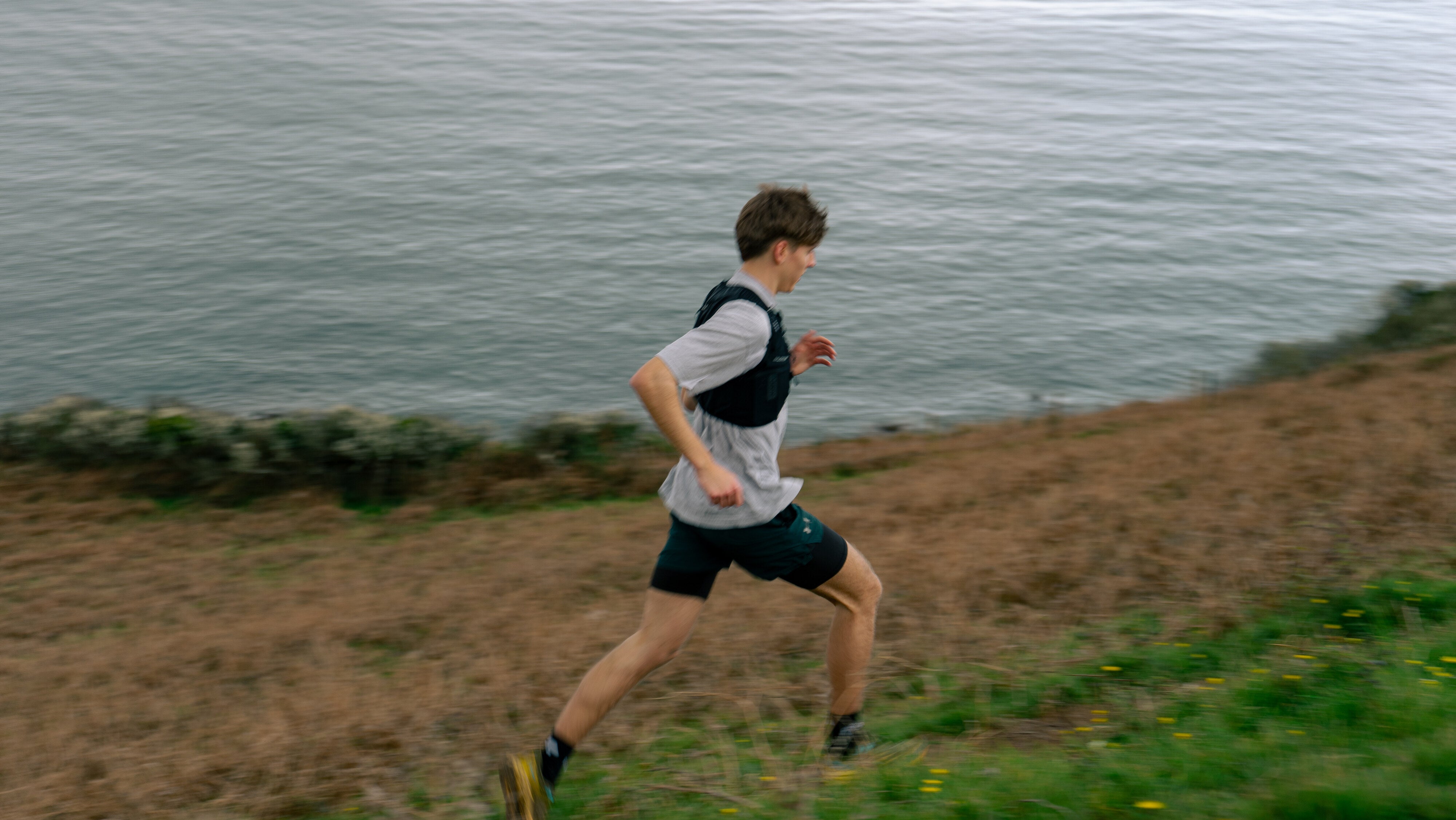 An image of a man trail running