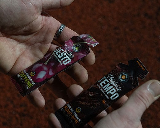 cyclist on a bike eating an energy gel