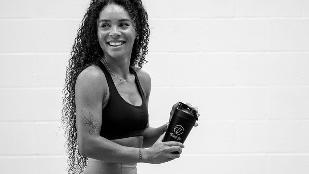 women holding protein shaker