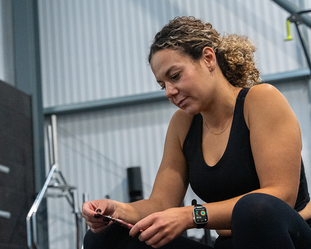 woman in a gym holding an energy gel