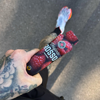 cyclist on a bike eating an energy gel