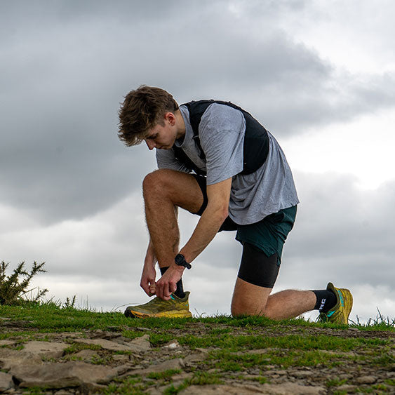 Runner tying his shoe