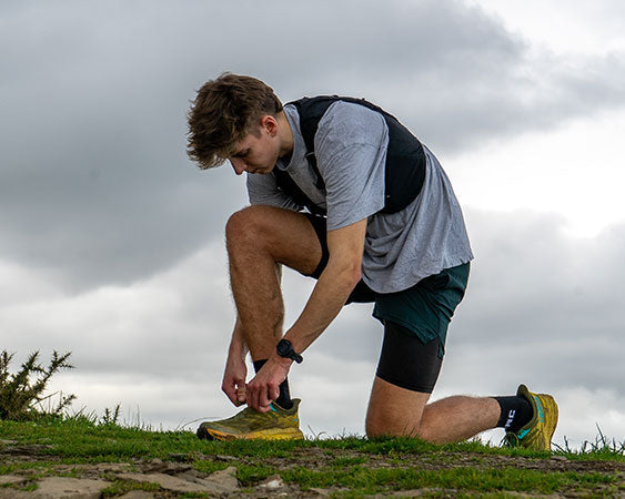 Runner tying his shoe