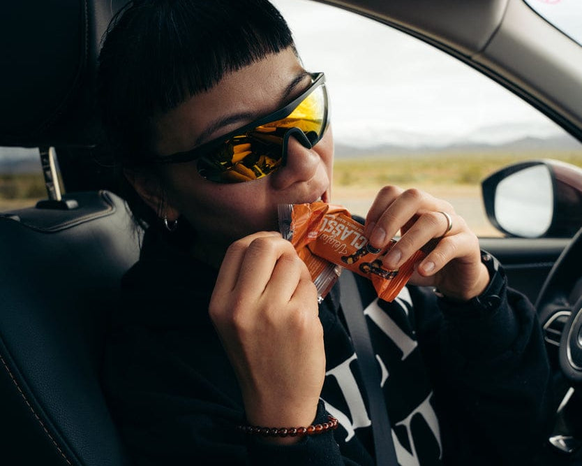 A woman eating a Veloforte Classico Energy Bar