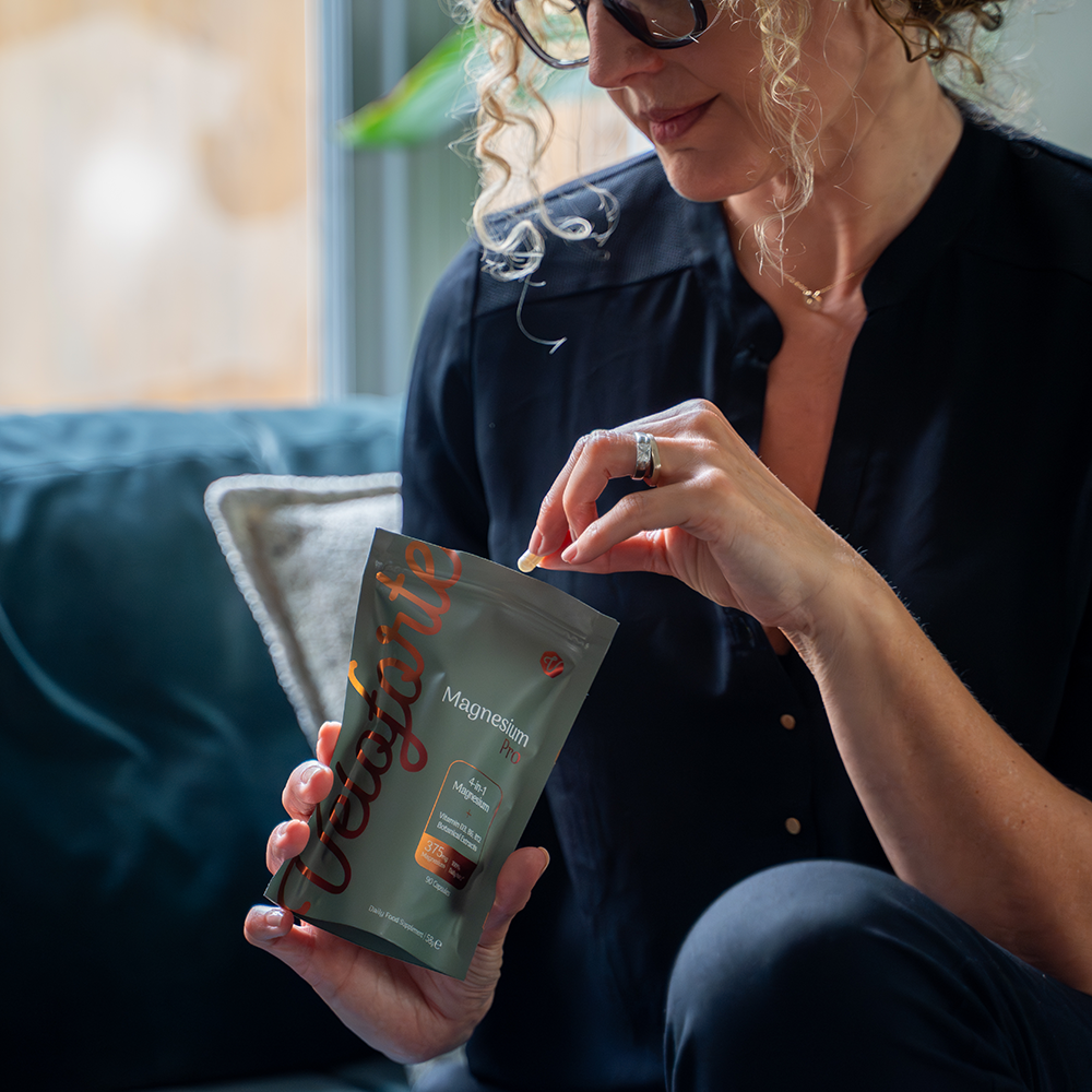 Woman taking Veloforte MagnesiumPro 4-in-1 Complex
