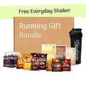 Running gift bundle with protein powder packages and a shaker bottle on a white background