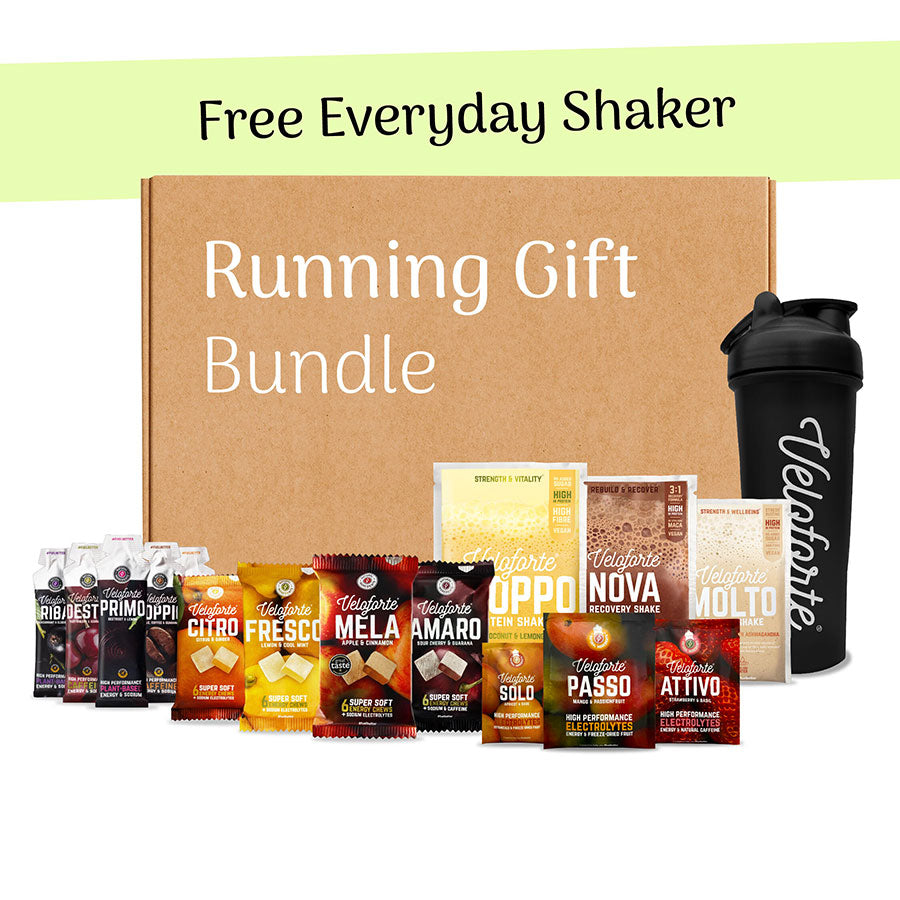 Running gift bundle with protein powder packages and a shaker bottle on a white background