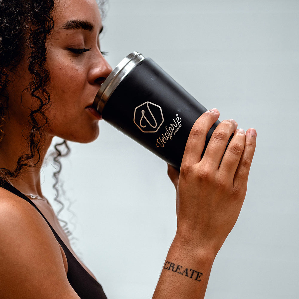 Woman drinking from a Veloforte protein shaker