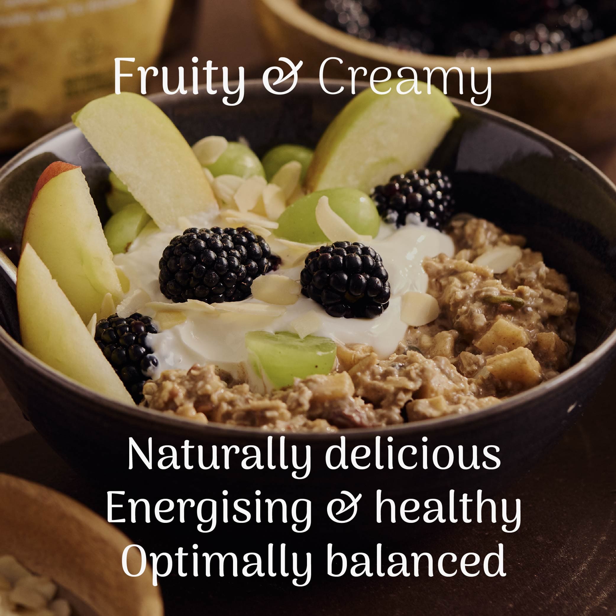 Bowl of overnight oats with fruit and berries, labeled 'Fruity & Creamy' on a dark background.
