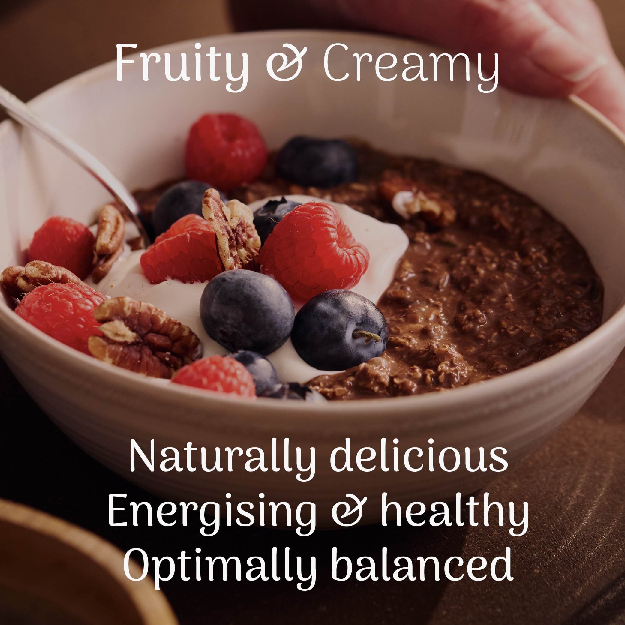  bowl of cocoa overnight oats with berries and nuts, labeled 'Fruity & Creamy' on a dark background