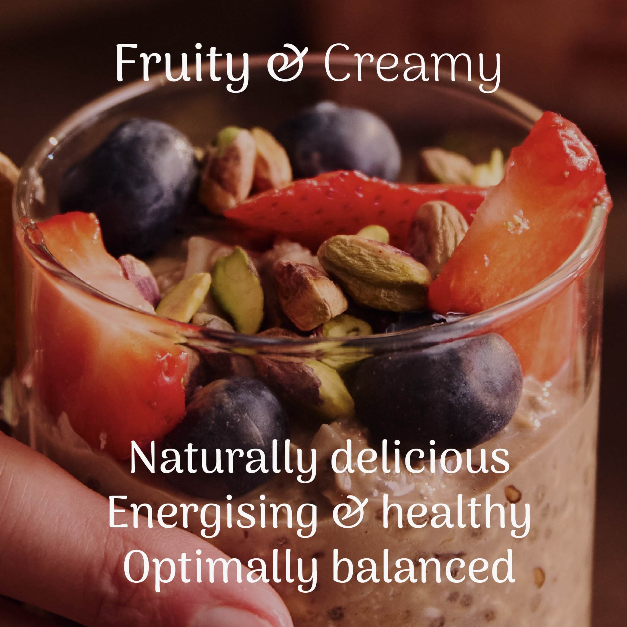 Glass of overnight oats with fruits and nuts, labeled 'Fruity & Creamy' on a dark background.