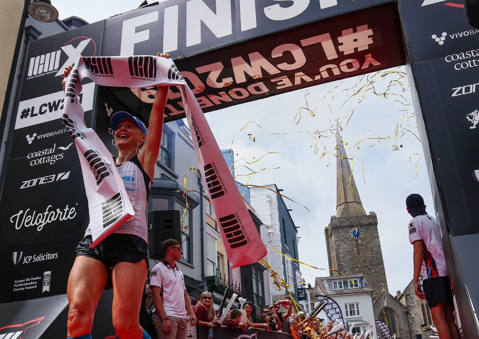 woman crossing the finish line of a marathon