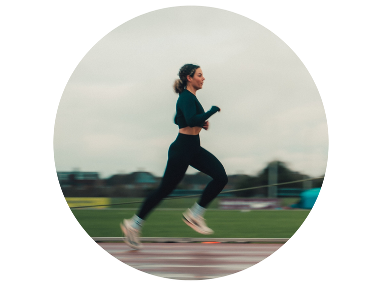 Person running on a track with a blurred background