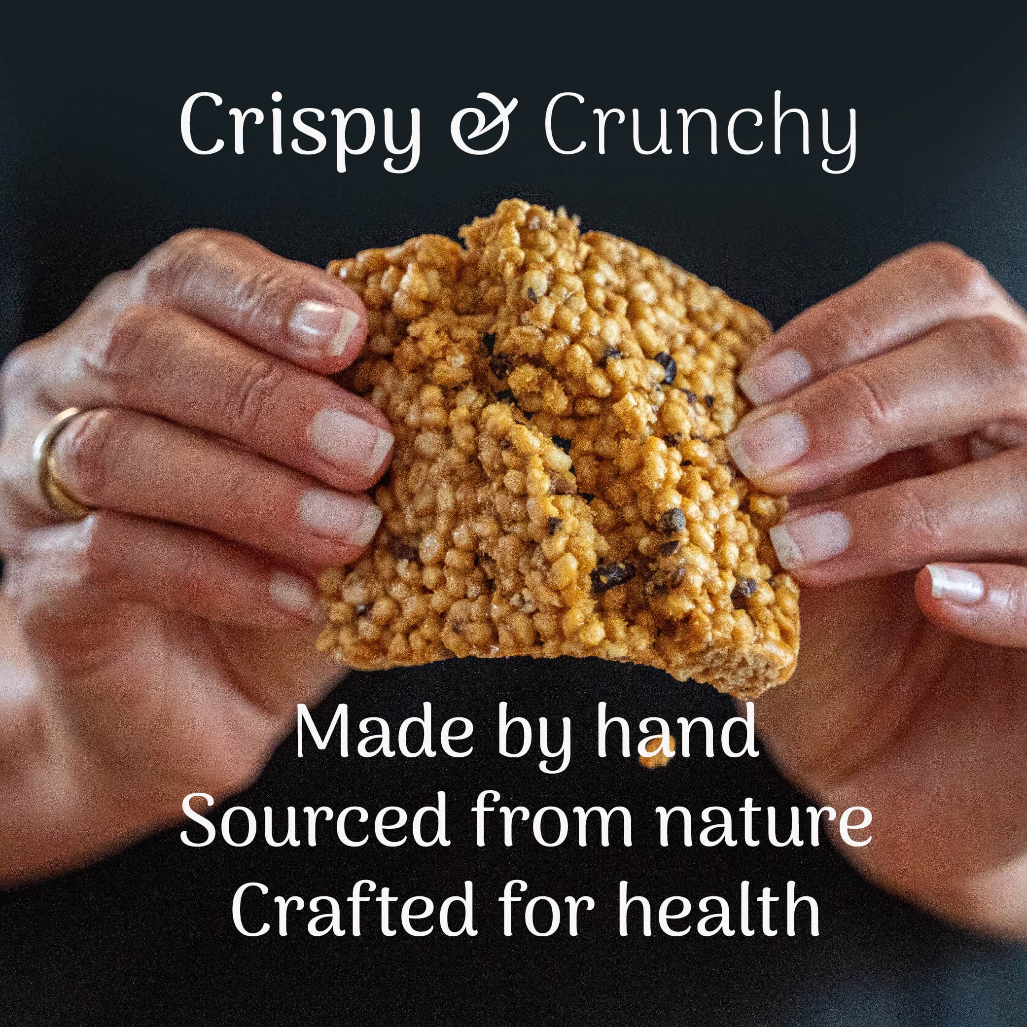 Hand holding a peanut and sea salt protein bar with text about its origin and health benefits.