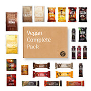 Vegan Complete Pack with various vegan snacks and bars displayed around a central cardboard box.