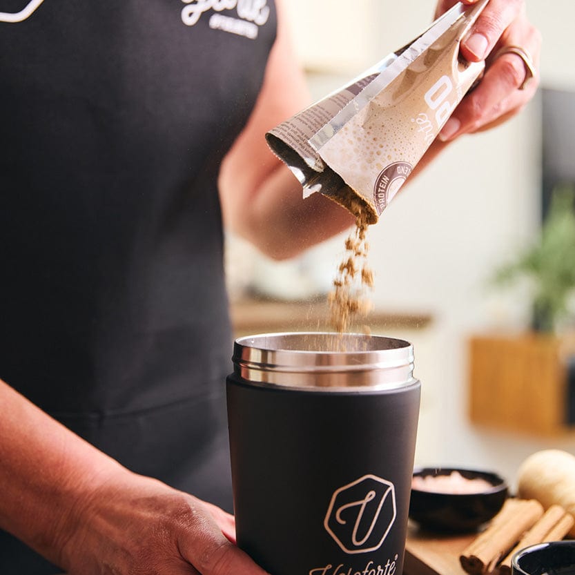 Woman emptying Veloforte Cappo Protein Shake into Protein Shaker